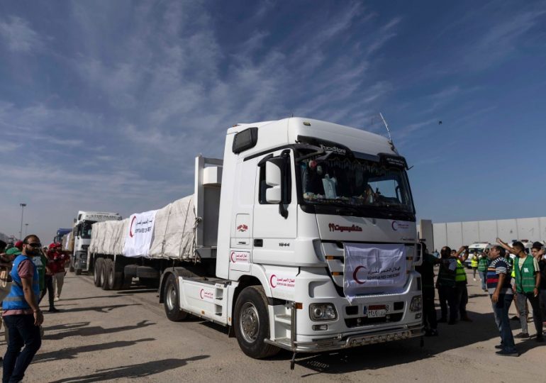 Aid trucks flow into besieged Gaza from Egypt after border deal as Israel tanks and 300k troops loom for invasion