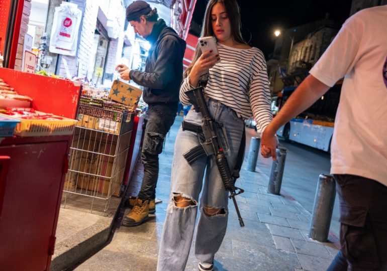 Israelis are armed to the teeth with assault rifles on date nights & days out as they take no chances after Hamas attack