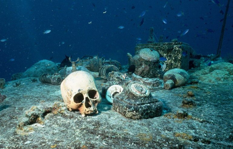 Haunting pictures show underwater graveyard beneath tropical paradise with human skulls and abandoned belongings