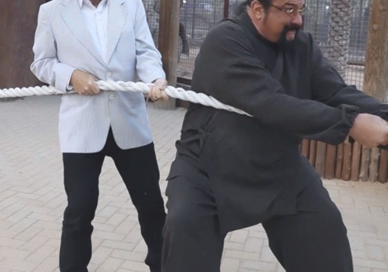Putin fan Steven Seagal & washed up politician George Galloway play tug of war with LIGER in Dubai zoo in bizarre snaps
