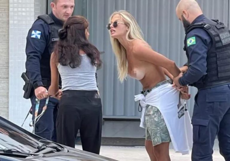Moment Brazilian model is arrested for being topless while walking her dogs as cops bundle her into police van