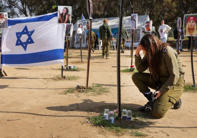 Israeli soldier pays tribute at memorial to those killed or taken hostage by Hamas at Supernova festival