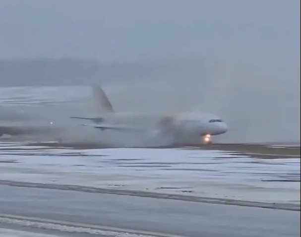 Terrifying moment passenger plane SKIDS off soaking runway and heads straight towards terminal in landing from hell