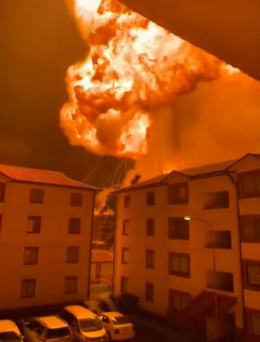 Terrifying mushroom cloud of flames erupts yards away from apartment blocks in Kenya as terrified residents flee