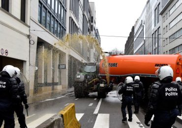 Why farmers across Europe are launching pitched battles over pay using grain sprayers as guns & blasting MANURE at cops