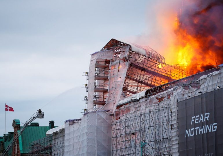 Massive fire rips through Denmark Stock Exchange as spire collapses & people rush to save priceless paintings