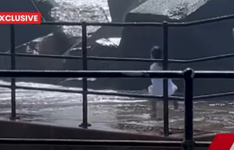 Shock moment dad leaps from sea wall into torrent after toddler is swept away by huge wave & onlookers watch in horror