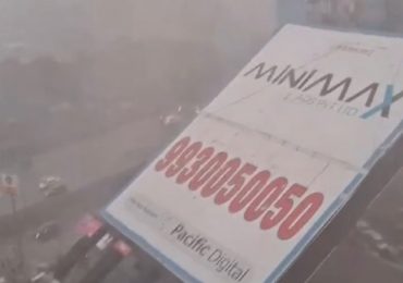 Horror moment giant 100ft billboard topples & crushes bystanders as dust storms smash India killing 4