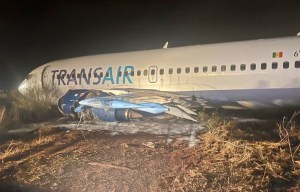 Boeing 737 plane carrying 73 passengers skids off runway as wing bursts into flames at Dakar airport in Senegal