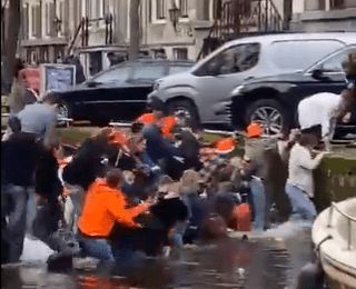 Hilarious moment revellers desperately scramble out of sinking party boat in Amsterdam canal after overcrowding vessel