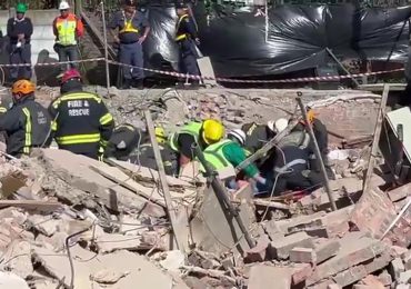 Moment rescuers cheer as survivor is pulled from rubble FIVE days after building collapsed in South Africa killing 13