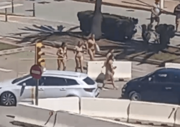 Moment near-NAKED tourists in bikinis are confronted by furious Majorca locals after spilling off boat for brazen stroll