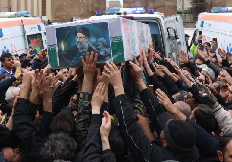 Thousands Attend Iranian President Raisi’s Funeral Procession, as Others Celebrate