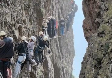 Watch horror moment terrified tourists are left dangling on 3,700ft mountain for an HOUR after ‘traffic jam’ on climb