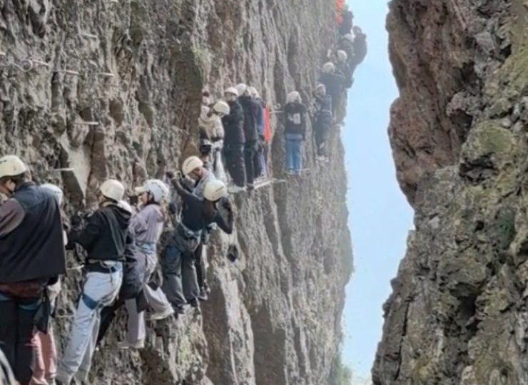 Watch horror moment terrified tourists are left dangling on 3,700ft mountain for an HOUR after ‘traffic jam’ on climb