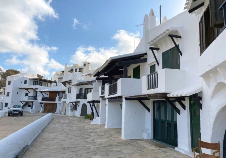 Furious locals CHAIN UP entrances to idyllic village to keep tourists out as thousands hit streets in Majorca & Menorca