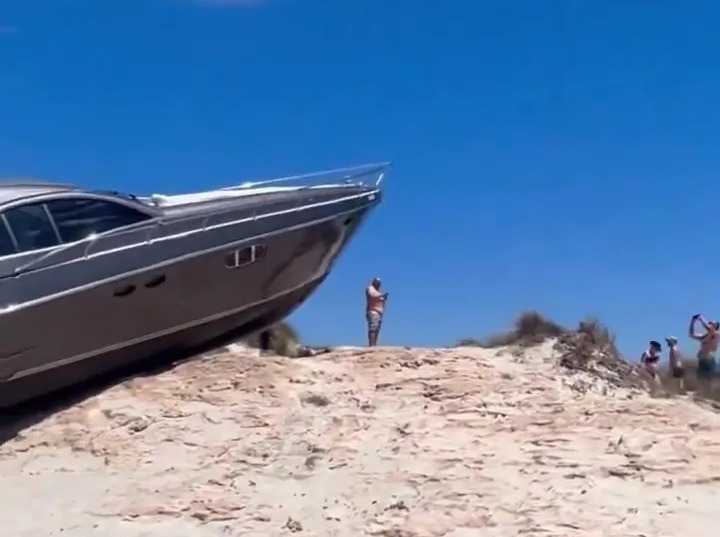 Shocking moment tourists find luxury yacht on top of sand dune after ‘navigation error’ sent it flying across beach