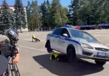 Shock moment police stunt goes horribly wrong as cop is crushed under car & dragged along road in front of shocked crowd
