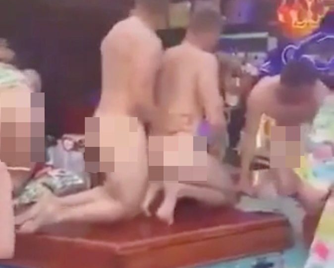 Shocking moment rowdy Brits strip NAKED and pile onto bartop sparking fury & vow for police crackdown in holiday hotspot