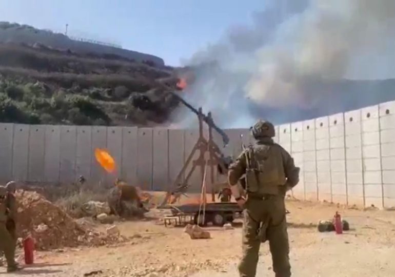 Israel deploys medieval war tactics as troops filmed catapulting flaming objects over Lebanon border to spark wildfires