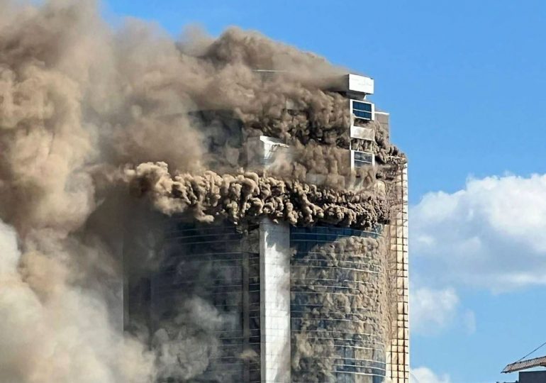 Shocking moment raging inferno engulfs residential skyscraper as firefighters search for people in burning building