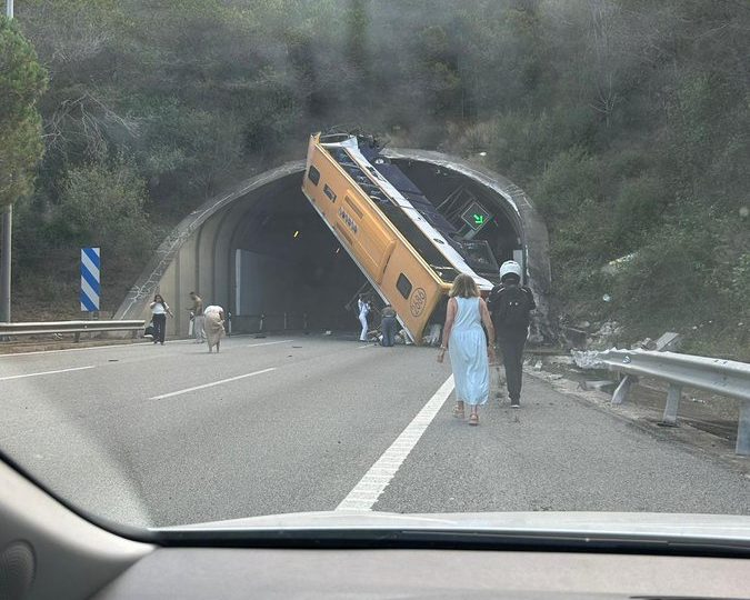 Two people trapped inside bus in Spain as dramatic pic shows flipped vehicle blocking mouth of tunnel