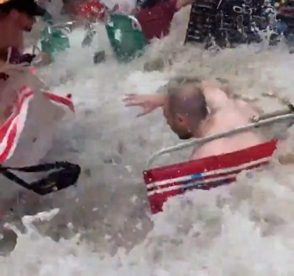 Watch moment freak 11ft high wave smashes into tourist beach washing away sunbathers, loungers & umbrellas