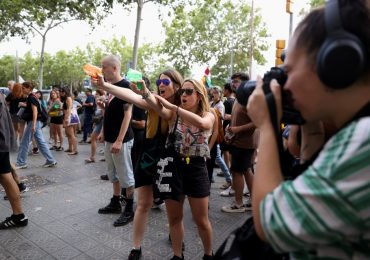 Anti-tourist protesters blast foreigners with WATER PISTOLS in march through Barcelona telling visitors to ‘go home’