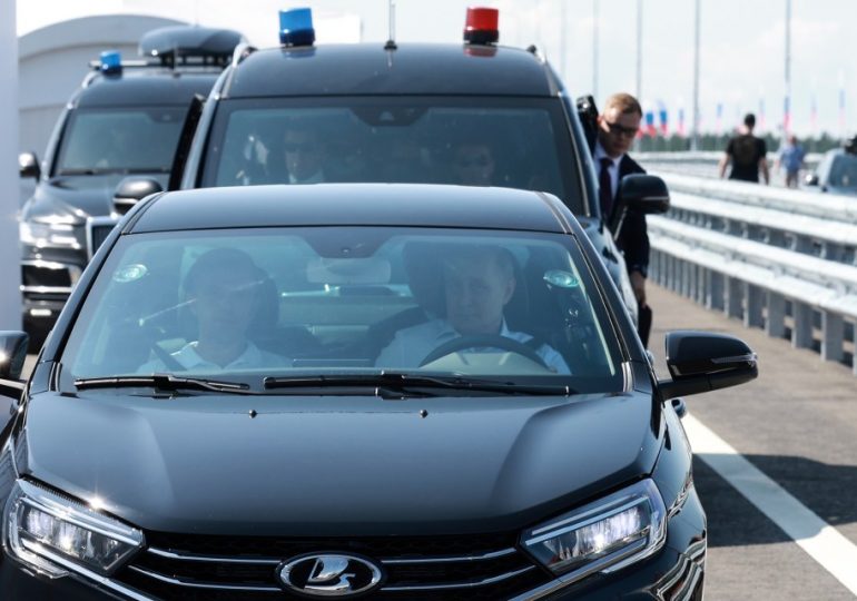 Putin makes major driving error while zooming around in new Lada to promote Russian cars – can YOU spot the error?