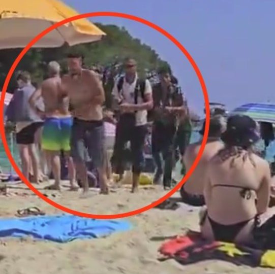 Moment haggard migrants step over stunned tourists on packed Brit holiday beach in MAJORCA after perilous 170 mile trip