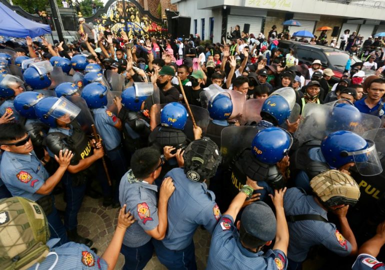 ‘Owner of the universe’ hides in underground ‘sex slave lair’ as cult diehards form human shield & clash with 2,000 cops