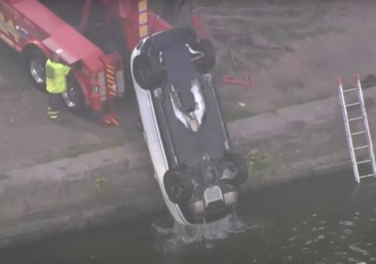 Raunchy couple flees sinking car after it rolls into RIVER while they romped in back seat