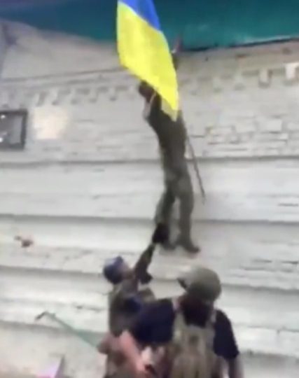 Watch moment cheering Ukrainian soldiers raise FLAG in ‘occupied’ Russia in latest humiliating blow for Putin