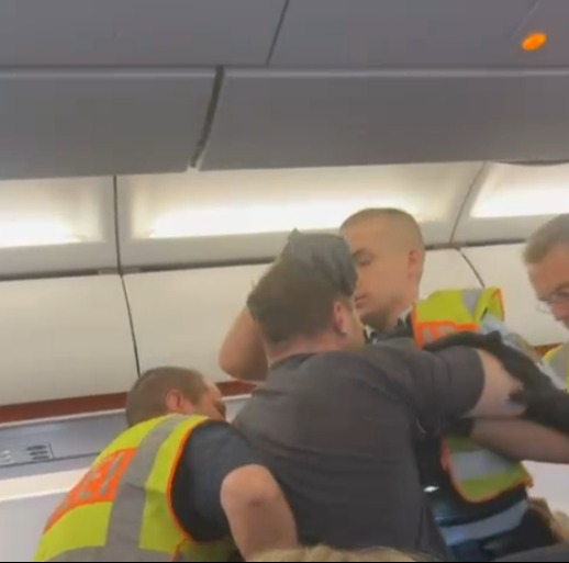 New vid shows drunk yob brawling at 30,000ft on EasyJet flight to Kos after downing swigs from ‘big bottle of whiskey’