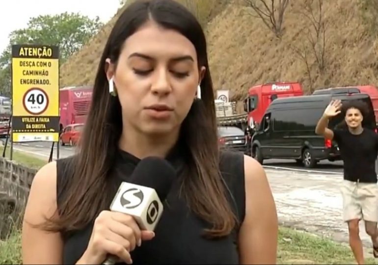 Sick moment influencer MC Livinho DANCES behind reporter at scene of deadly bus crash on live TV sparking fury