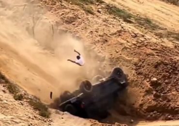 Watch terrifying moment driver is hurled from window of barrel-rolling car after it plummets off edge of quarry