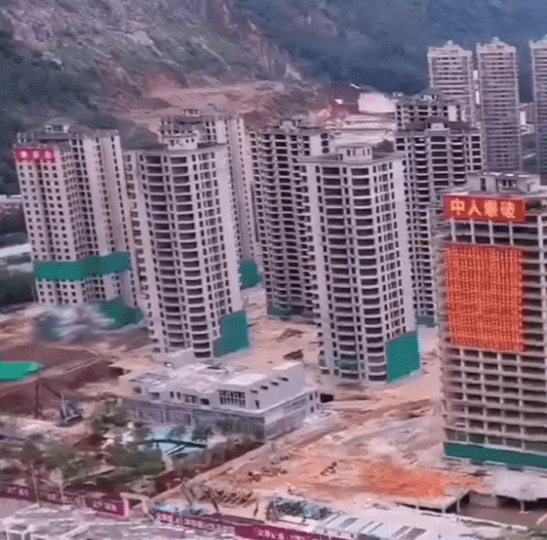 Watch moment 15 abandoned high rises are DEMOLISHED in just seconds after Chinese builders ‘ran out of money’