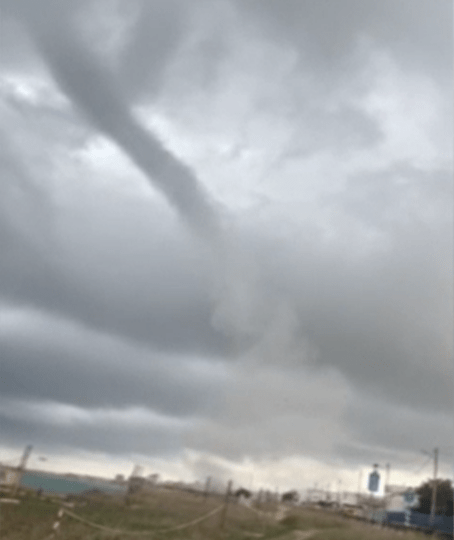 Watch moment towering waterspout tornado slams into beach sending bathers fleeing running and hurling tables & chairs