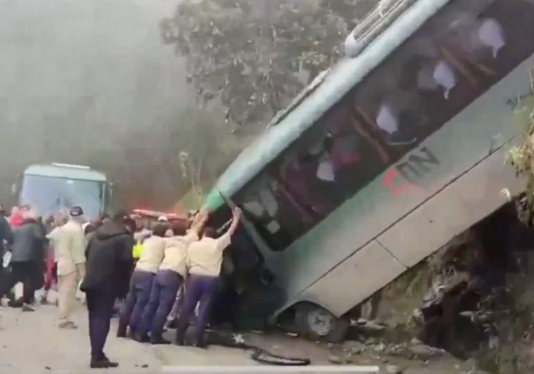 Tourist bus plunges off cliff at iconic landmark as locals try to stop it rolling down mountain with their bare hands