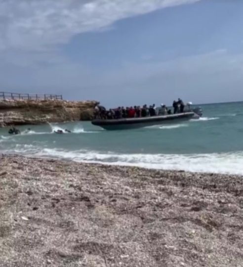 Brit tourists ‘traumatised’ as vid shows migrants land at Spanish beach before running past holidaymakers’ sunbeds