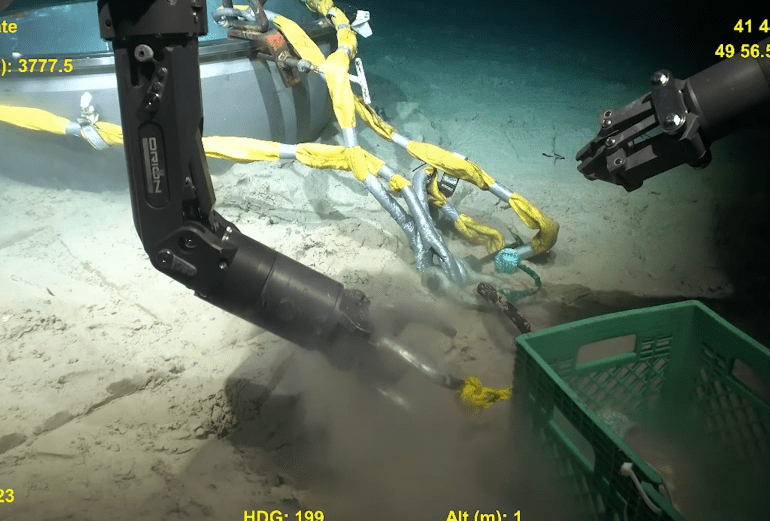 Eerie moment underwater drone robot picks through crumpled wreckage of imploded Titan sub in haunting new footage