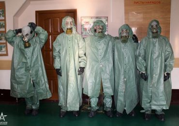 Chilling moment Russian schoolchildren dress in haunting hazmat gear as Putin grooms kids to fear Western bio-war strike