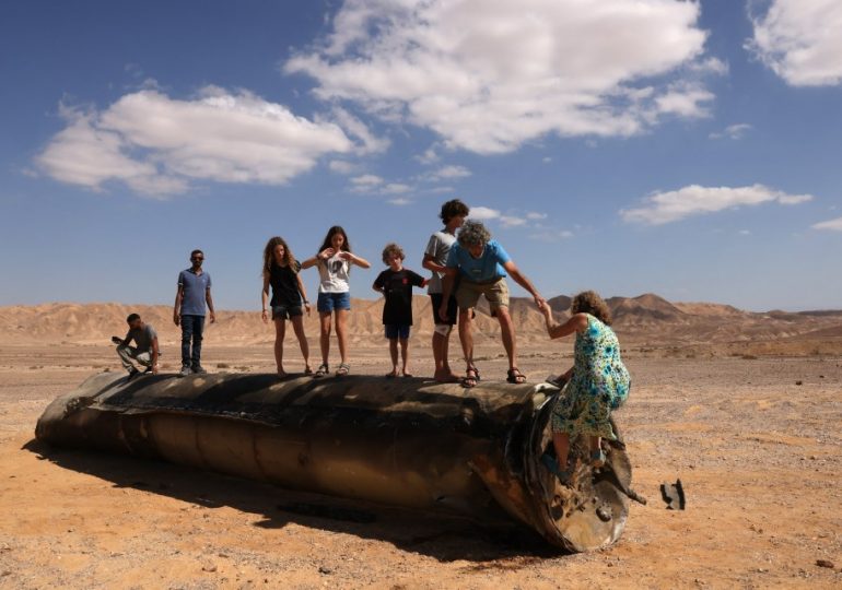 Defiant kids play on Iranian rocket as Israelis hail ‘miracle of Tel Aviv’ after just one killed in 181-missile blitz