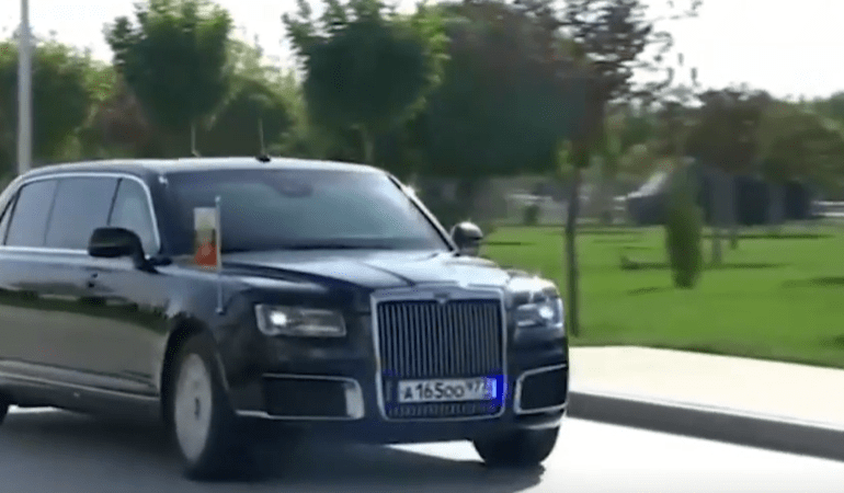 Moment Putin breaks bizarre law as he arrives for surprise axis-of-evil Iran summit in bomb-proof presidential limo