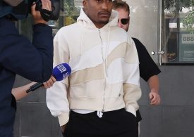 Watch moment UK rapper Yung Filly dodges TV reporter as he visits Australian police station on bail after rape charge