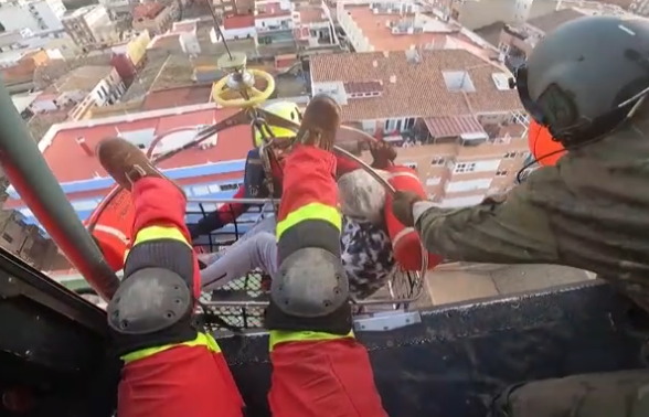 Moment rescuers airlift baby & elderly woman in flooded Spain amid painstaking rescue mission after at least 158 killed