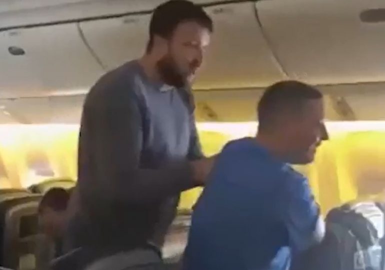 Moment ‘drunk’ airline safety instructor is wrestled to floor after ‘sparking mid-air brawl’ & trying to ‘hit crew’