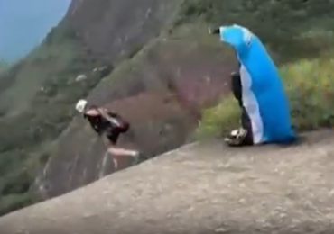 Horror moment skydiving instructor walks to his death off cliff in front of horrified thrillseekers in stunt gone wrong