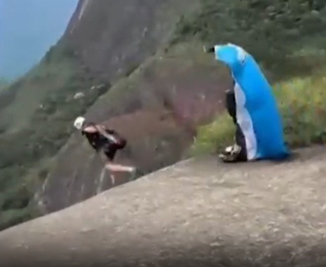 Horror moment skydiving instructor walks to his death off cliff in front of horrified thrillseekers in stunt gone wrong