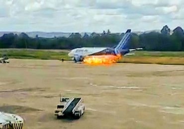 Horror moment fire erupts from plane’s engine forcing passengers to leap from jet’s emergency exit onto runway